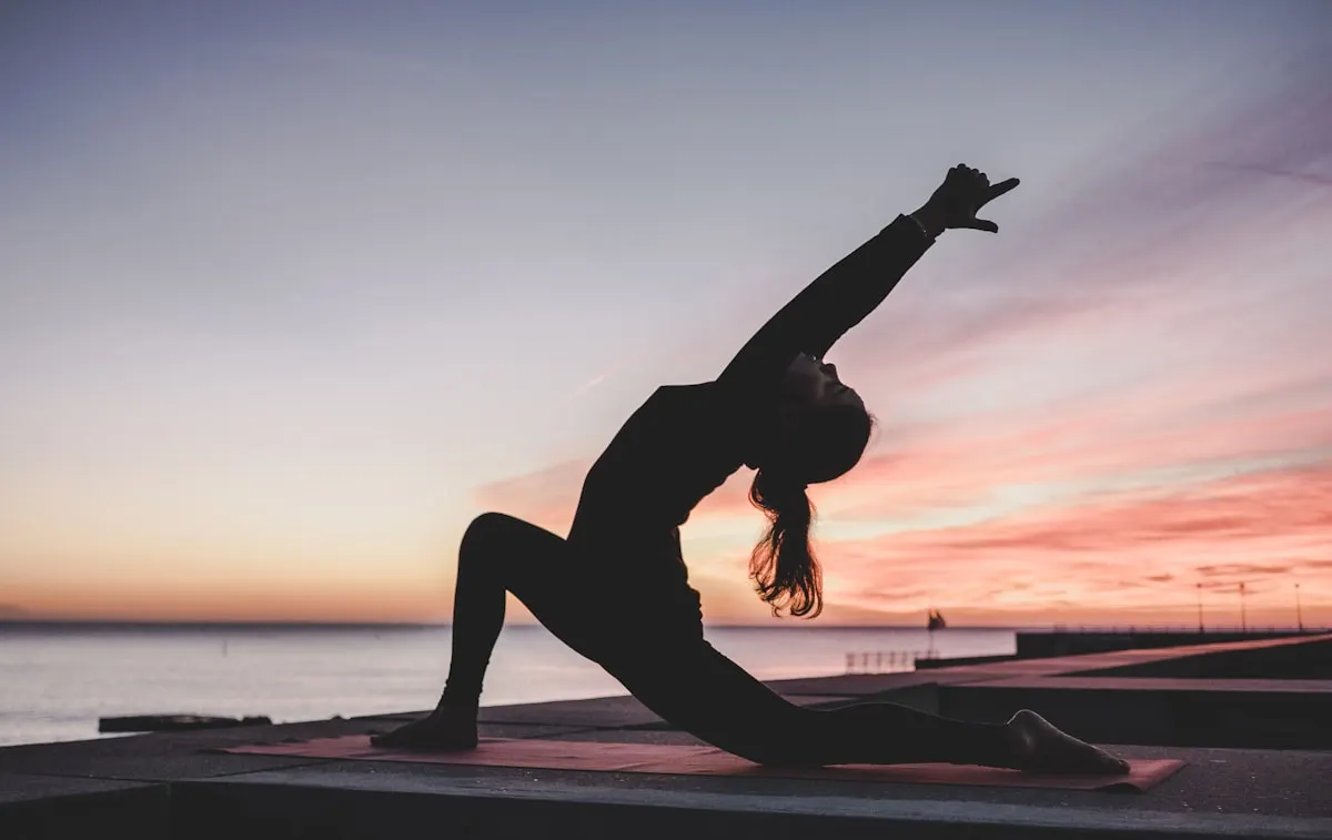Person stretching outdoors at sunrise — illustrative photograph